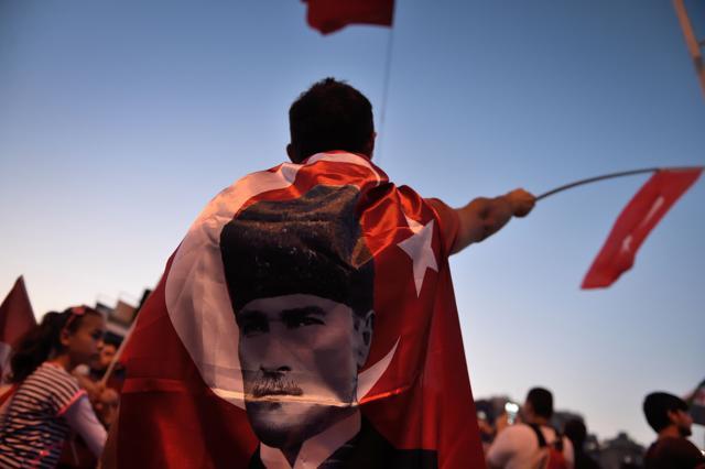 A boy is wrapped in a flag of the founder of modern Turkey Mustafa Kemal Ataturk on Taksim square, following a failed coup attempt. (AFP) A boy is wrapped in a flag of the founder of modern Turkey Mustafa Kemal Ataturk on Taksim square, following a failed coup attempt. (AFP)