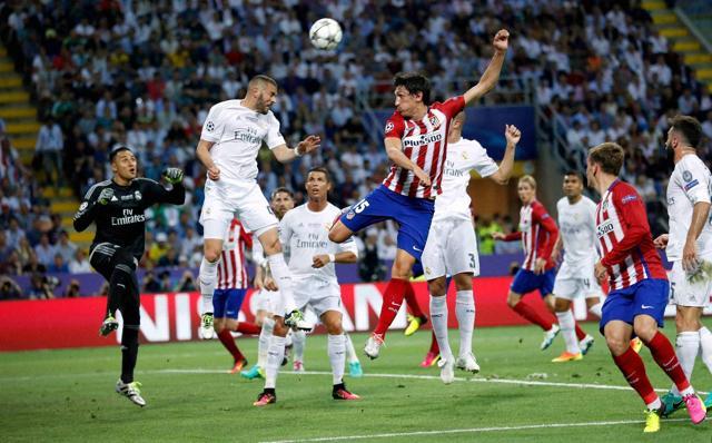 Atletico Madird's Stefan Savic (center right) and Real Madrid's Karim Benzema jump for the ball during the Champions League final match between Real Madrid and Atletico Madrid at the San Siro stadium in Milan. (AP Photo) Atletico Madird's Stefan Savic (center right) and Real Madrid's Karim Benzema jump for the ball during the Champions League final match between Real Madrid and Atletico Madrid at the San Siro stadium in Milan. (AP Photo)