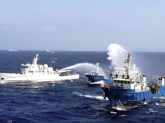 This July 14 photo shows Chinese ships putting out a fire on a mock cargo vessel during an emergency drill in the South China Sea near Sansha, in south China's Hainan province.(AFP)