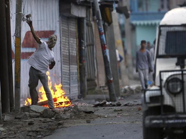 A Kashmiri protester throws a stone at an Indian police vehicle during a protest in Srinagar, Kashmir. (AP Photo) A Kashmiri protester throws a stone at an Indian police vehicle during a protest in Srinagar, Kashmir. (AP Photo)