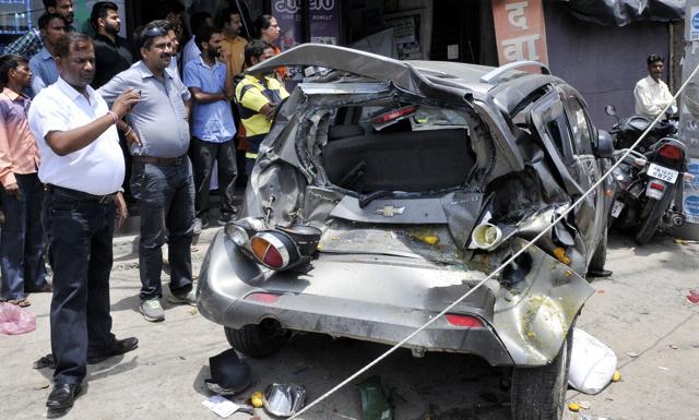 The damaged car at Jamalpur Chowk after being hit by the bus. (JS Grewal/HT Photo)