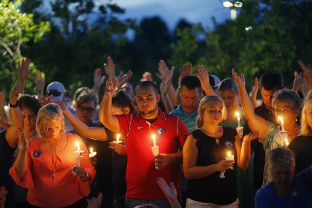 People holds up their hands in prayer during a candlelight vigil for fallen Baton Rouge police officers at the Healing Place Church in Baton Rouge. (AP Photo) People holds up their hands in prayer during a candlelight vigil for fallen Baton Rouge police officers at the Healing Place Church in Baton Rouge. (AP Photo)