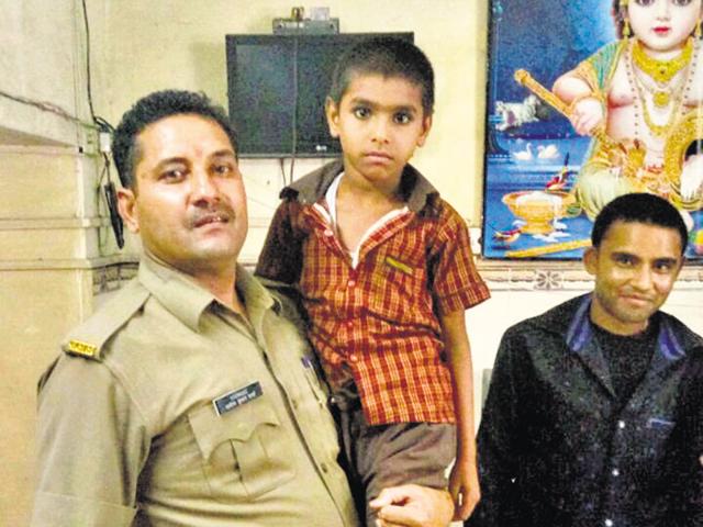 Ankush with Ghaziabad police constable Adesh Kumar Sharma whose efforts helped trace his family in Delhi. Ankush with Ghaziabad police constable Adesh Kumar Sharma whose efforts helped trace his family in Delhi.