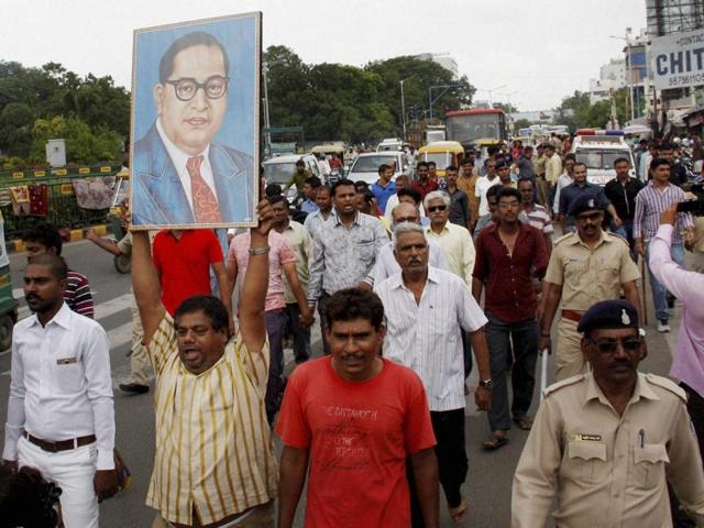 People from the Dalit community block a road during a protest against the flogging of four men accused of skinning a cow, in Ahmedabad on Wednesday.(Reuters) People from the Dalit community block a road during a protest against the flogging of four men accused of skinning a cow, in Ahmedabad on Wednesday.(Reuters)