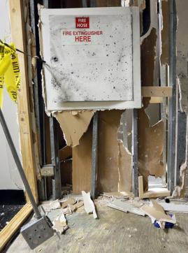 A corner of a hallway wall and fire extinguisher station are shown at El Centro College. (AP Photo)