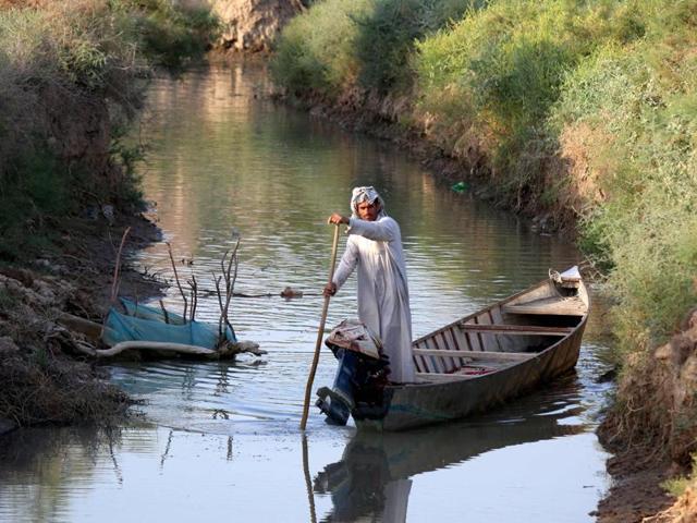 An Iraqi man rides a boat in the Ahwar area in the southern Maysan province -- also known as the Iraqi Marshlands -- one of the world's largest inland delta systems. (AFP)
