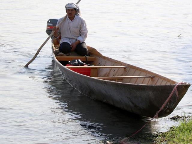 An Iraqi man rides a boat. The marshlands are one of the world’s largest inland delta systems. (AFP)