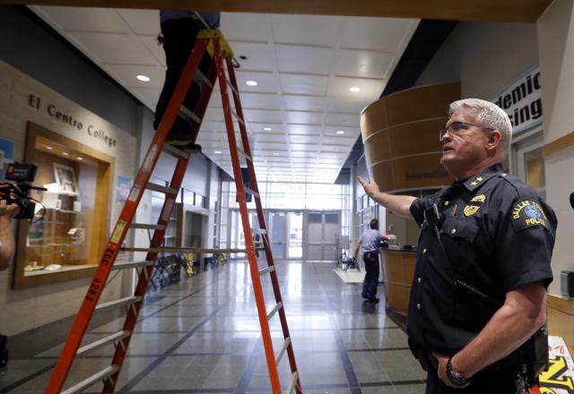 Workers continued to make repairs as El Centro College Police chief Joseph Hannigan gives a tour to the media retracing the path Micah Johnson took once he entered the downtown campus. (AP Photo)
