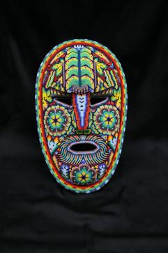 A mask decorated with wooden beads. A mask decorated with wooden beads.