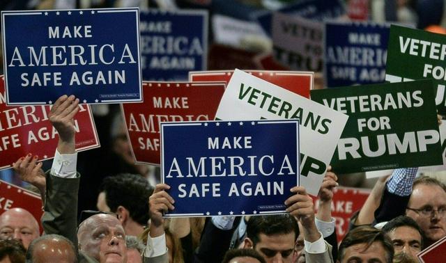Delegates hold signs on the first day of the Republican National Convention at the Quicken Loans Arena in Cleveland, Ohio. (AFP Photo) Delegates hold signs on the first day of the Republican National Convention at the Quicken Loans Arena in Cleveland, Ohio. (AFP Photo)