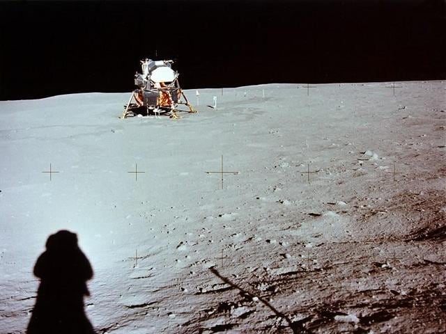 Armstrong taking a photograph of the lunar module parked on the moon’s surface. His shadow can be seen at the left.  (NASA) 