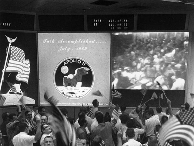 Back home, members of the mission control celebrate the moon landing.  (NASA) 