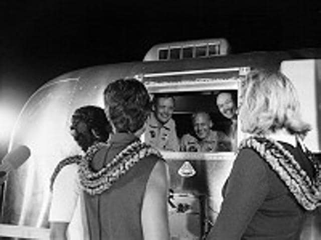 Apollo 11 astronauts, still in their quarantine van, are greeted by their wives upon arrival at Ellington Air Force Base.  (NASA) 