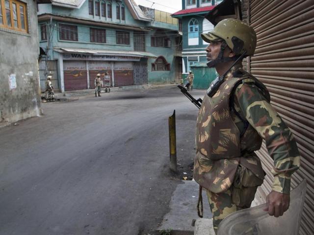 Paramilitary soldiers stand guard outside a closed market during curfew in Srinagar. (AP) Paramilitary soldiers stand guard outside a closed market during curfew in Srinagar. (AP)