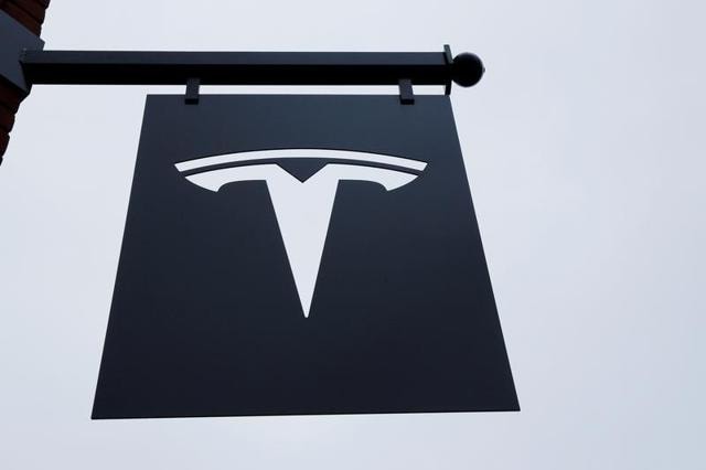 A Tesla logo hangs on a building outside of a Tesla dealership in New York (Reuters file photo) A Tesla logo hangs on a building outside of a Tesla dealership in New York (Reuters file photo)