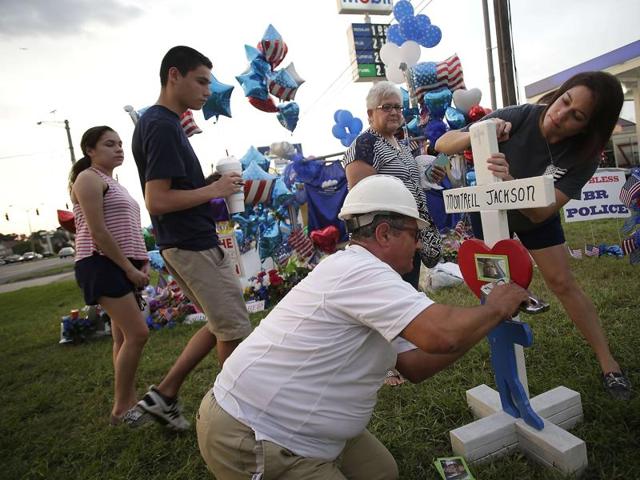 Parishioners light candles during a prayer service for for Baton Rouge Police Officers Montrell Jackson, Matthew Gerald and East Baton Rouge Parish Sheriff Deputy Brad Garafola at Trinity Episcopal Church July 20, 2016 in Baton Rouge, Louisiana. Jackson, Gerald and Granola were killed by Gavin Long, who ambushed the law enforcement officers along Airline Highway Sunday morning and wounding several others. (AFP) Parishioners light candles during a prayer service for for Baton Rouge Police Officers Montrell Jackson, Matthew Gerald and East Baton Rouge Parish Sheriff Deputy Brad Garafola at Trinity Episcopal Church July 20, 2016 in Baton Rouge, Louisiana. Jackson, Gerald and Granola were killed by Gavin Long, who ambushed the law enforcement officers along Airline Highway Sunday morning and wounding several others. (AFP)