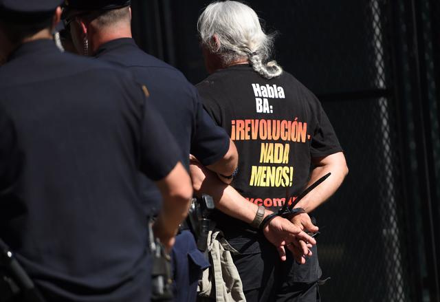 Protesters are arrested after an attempt to burn US flag, on the third day of the Republican National Convention. (AFP) Protesters are arrested after an attempt to burn US flag, on the third day of the Republican National Convention. (AFP)
