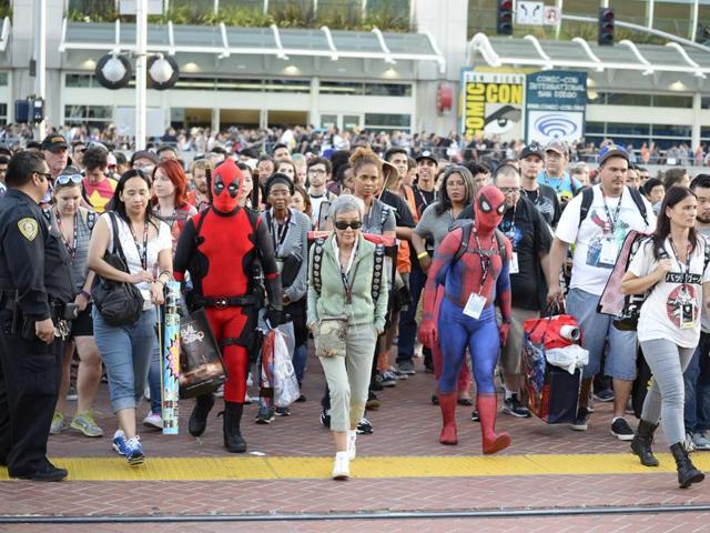 Fans leave the convention centre on day one of Comic-Con International held at the San Diego Convention Centre. (Denis Poroy/Invision/AP) Fans leave the convention centre on day one of Comic-Con International held at the San Diego Convention Centre. (Denis Poroy/Invision/AP)
