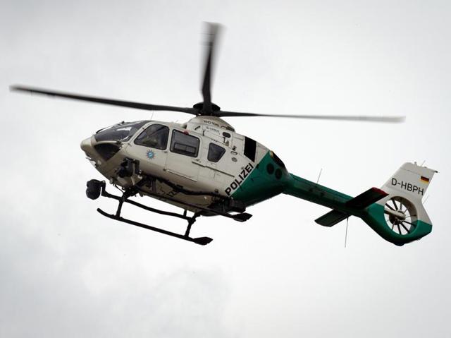 A police helicopter patrols over a shopping mall following a shooting in Munich. (AFP Photo) A police helicopter patrols over a shopping mall following a shooting in Munich. (AFP Photo)