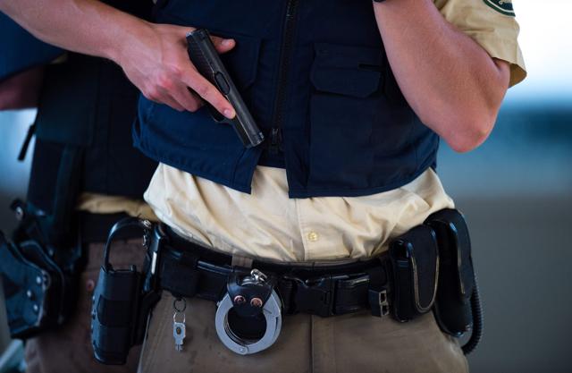 A policeman stands with a gun near a shopping mall following shootings. (AFP) A policeman stands with a gun near a shopping mall following shootings. (AFP)