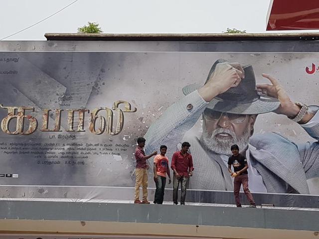 Fans do the ‘pal abhishekam’ (milk bath) at the Albert Theatre on Friday. (Aditya Iyer/HT Photo)