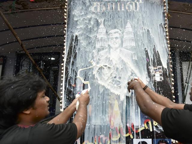 Fans shower Rajini’s poster with milk. (Photo by Arijit Sen/ Hindustan Times)