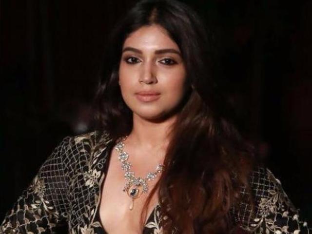 Bollywood actress Bhumi Pednekar extended support to the ace designer and sported a floor-length black jacket adorned with gold embellishments from the collection Epic Love. (Amal KS/ HT Photo) Bollywood actress Bhumi Pednekar extended support to the ace designer and sported a floor-length black jacket adorned with gold embellishments from the collection Epic Love. (Amal KS/ HT Photo)