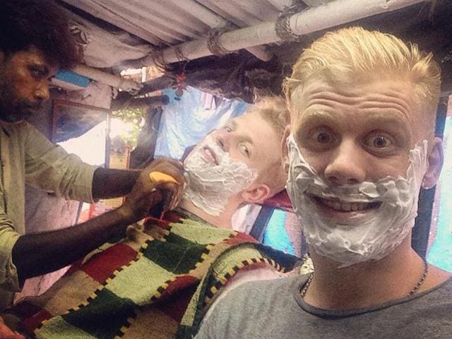 Johan Bartoli and Hampus Bergqvist get a shave at a streetside barber shop.