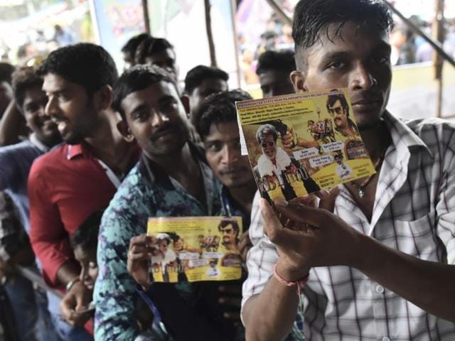Rajinikanth fans flaunt their Kabali first day ticket as they enter to watch the movie on its release at Aurora talkies in Mumbai. (Photo by Arijit Sen/ Hindustan Times)