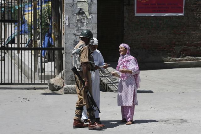 Paramilatary soldier checks a medicine prescription of an old Kashmir couple during curfew in Srinagar. (Waseem Andrabi / HT Photo ) Paramilatary soldier checks a medicine prescription of an old Kashmir couple during curfew in Srinagar. (Waseem Andrabi / HT Photo )