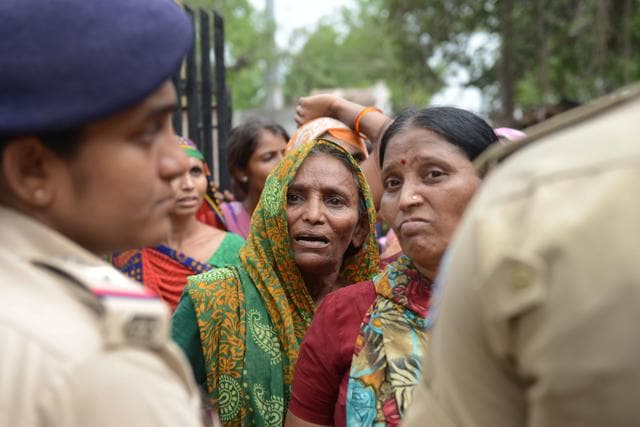 An Indian Dalit woman waits for a relative's release from a police station after protestors were detained by police for damaging vehicles and disturbing peace, at Dholka town, some 40 kms from Ahmedabad on Thursday. (AFP) An Indian Dalit woman waits for a relative's release from a police station after protestors were detained by police for damaging vehicles and disturbing peace, at Dholka town, some 40 kms from Ahmedabad on Thursday. (AFP)