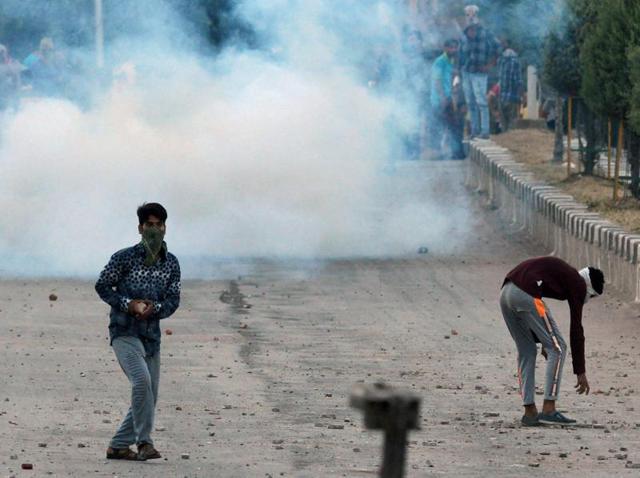 Kashmiri protesters throw stones after troops fired tear gas during clashes in Srinagar. (AFP Photo) Kashmiri protesters throw stones after troops fired tear gas during clashes in Srinagar. (AFP Photo)