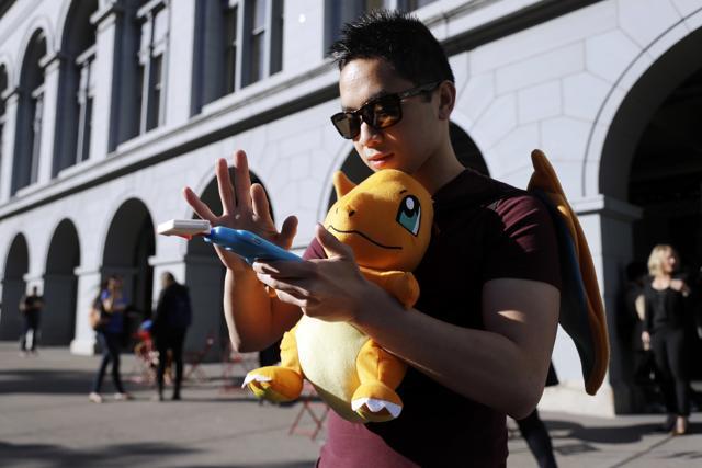 Tim C searches for Pokemon during a gathering of ‘Pokemon Go’ players on July 20, 2016 in San Francisco. (AP)