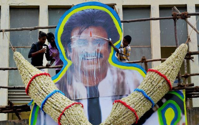 A fan pours milk on the poster of superstar Rajinikanth in Bengaluru on Friday. (PTI) A fan pours milk on the poster of superstar Rajinikanth in Bengaluru on Friday. (PTI)