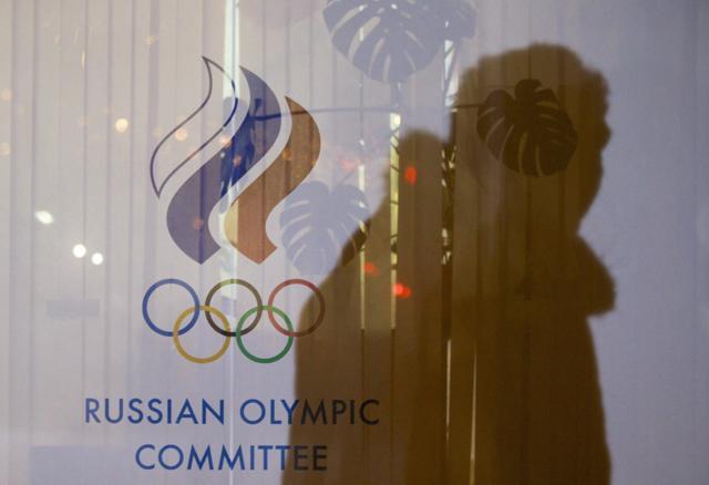 A file photo of a man walking past the Russian Olympic Committee building. (AP Photo) A file photo of a man walking past the Russian Olympic Committee building. (AP Photo)