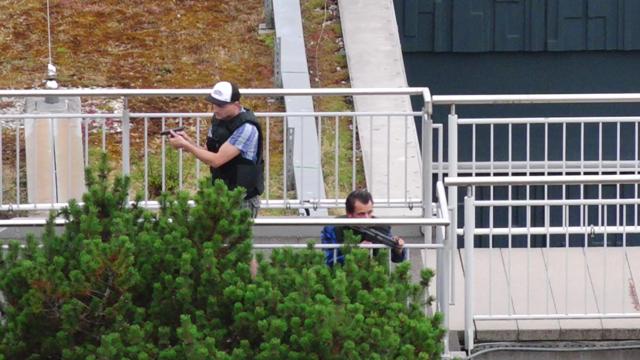 A screen grab taken from video footage shows plain clothes police officers at the scene of a shooting rampage at the Olympia shopping mall in Munich, Germany July 22, 2016. (REUTERS) A screen grab taken from video footage shows plain clothes police officers at the scene of a shooting rampage at the Olympia shopping mall in Munich, Germany July 22, 2016. (REUTERS)