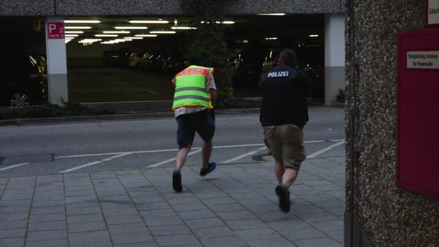 A screen grab taken from video footage shows plainclothes police officers running towards car park of the Olympia shopping mall during shooting rampage in Munich. (REUTERS) A screen grab taken from video footage shows plainclothes police officers running towards car park of the Olympia shopping mall during shooting rampage in Munich. (REUTERS)