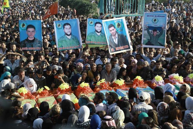 People mourn over the coffins of members of the Syrian Democratic Forces (SDF) in Syria's northeastern city of Qamishli on Thursday during the funeral of sixteen fighters killed battling the Islamic State (IS) group in Manbij. (AFP) People mourn over the coffins of members of the Syrian Democratic Forces (SDF) in Syria's northeastern city of Qamishli on Thursday during the funeral of sixteen fighters killed battling the Islamic State (IS) group in Manbij. (AFP)
