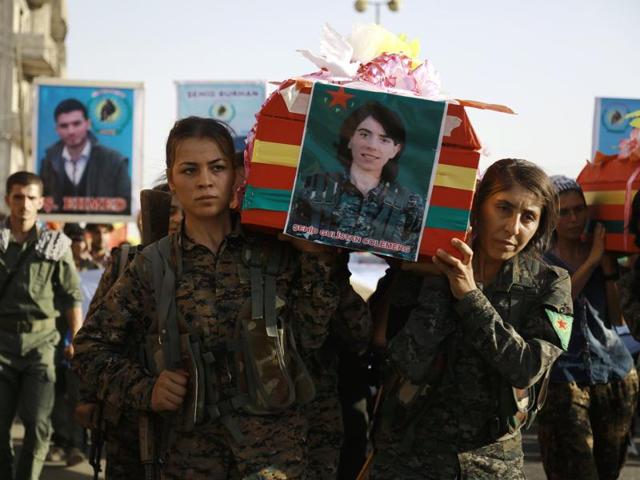 Syrian-Kurdish women carry the coffin of a female fighter in Syria's northeastern city of Qamishli on Thursday during the funeral of sixteen fighters killed battling the Islamic State (IS) group in Manbij. (AFP) Syrian-Kurdish women carry the coffin of a female fighter in Syria's northeastern city of Qamishli on Thursday during the funeral of sixteen fighters killed battling the Islamic State (IS) group in Manbij. (AFP)