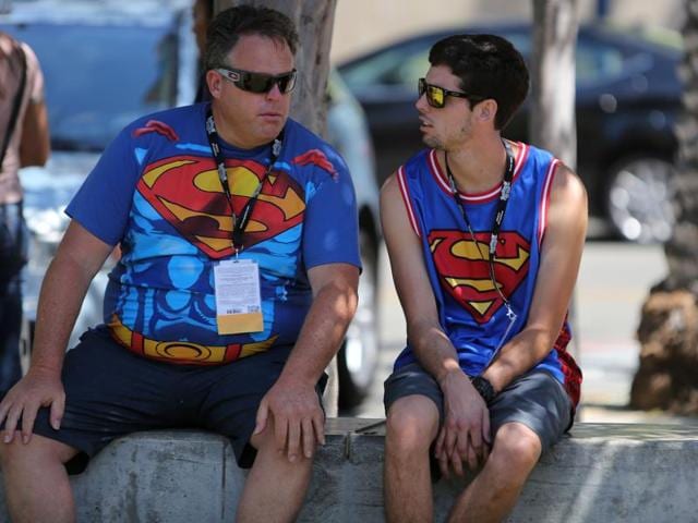 Father and son Superman team, Randy and Randy Rousseau of San Bernadino, California, enjoy a quick break in the shade during Comic-Con International 2016 in San Diego, California. (AFP) Father and son Superman team, Randy and Randy Rousseau of San Bernadino, California, enjoy a quick break in the shade during Comic-Con International 2016 in San Diego, California. (AFP)