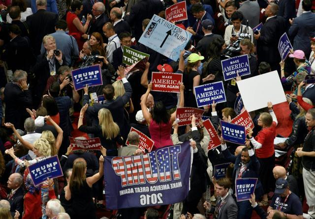 Delegates crowd the floor with sign of support on the final night at the Republican National Convention at the Quicken Loans Arena in Cleveland (AFP) Delegates crowd the floor with sign of support on the final night at the Republican National Convention at the Quicken Loans Arena in Cleveland (AFP)
