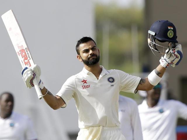 Virat Kohli celebrates after he scored a century during day one of their first Test match against West Indies at the Sir Vivian Richards Stadium in North Sound, Antigua. (AP Photo) Virat Kohli celebrates after he scored a century during day one of their first Test match against West Indies at the Sir Vivian Richards Stadium in North Sound, Antigua. (AP Photo)