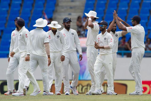 India cricketer players celebrate during day three of the cricket test match between West Indies and India. (AFP Photo) India cricketer players celebrate during day three of the cricket test match between West Indies and India. (AFP Photo)