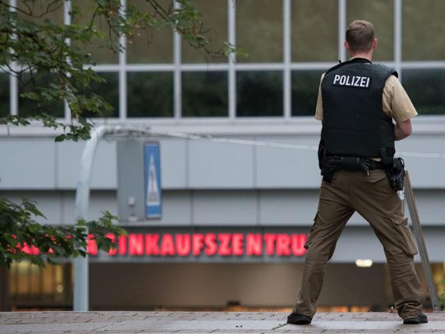 A police officer stands outside the Olympia mall in Munich, southern Germany, Friday, July 22, 2016 after shots were fired. (AP) A police officer stands outside the Olympia mall in Munich, southern Germany, Friday, July 22, 2016 after shots were fired. (AP)