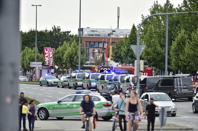 Police cars stand outside the Olympia shopping centre after a shooting was reported there in Munich. (AP Photo) Police cars stand outside the Olympia shopping centre after a shooting was reported there in Munich. (AP Photo)