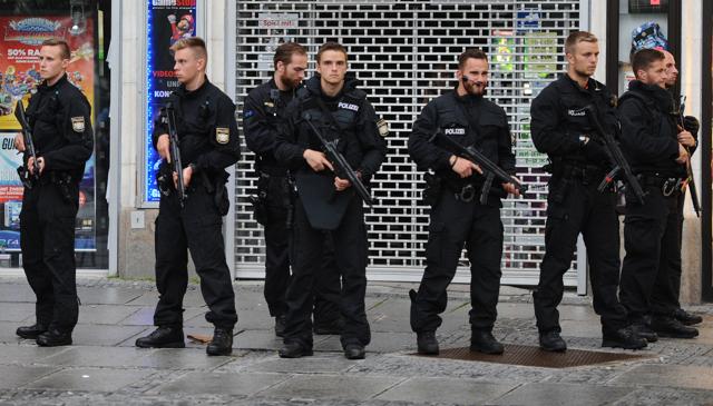 Police officers secure the Stachus hotel after a shooting was reported there in Munich, southern Germany, Friday, July 22, 2016. Several people have been reported to be killed. (AP) Police officers secure the Stachus hotel after a shooting was reported there in Munich, southern Germany, Friday, July 22, 2016. Several people have been reported to be killed. (AP)
