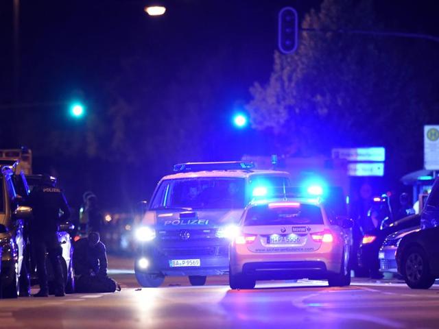 Police officers secure the area near the shopping mall the Olympia Einkaufzentrum in Munich on Friday night following a shooting earlier. At least nine people were killed by a German-Iranian gunman who committed suicide afterwards.(AFP)