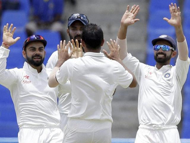 India cricketer Mohammed Shami (C) is congratulated by teammates during day two against West Indies. (AFP Photo) India cricketer Mohammed Shami (C) is congratulated by teammates during day two against West Indies. (AFP Photo)