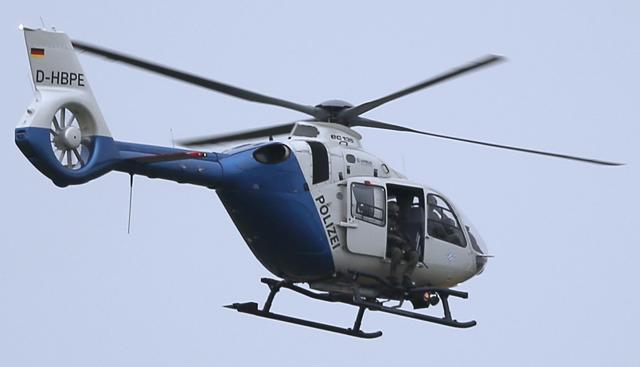 A police sniper sits in a helicopter above the scene of a shooting rampage at the Olympia shopping mall in Munich, Germany. (Reuters Photo) A police sniper sits in a helicopter above the scene of a shooting rampage at the Olympia shopping mall in Munich, Germany. (Reuters Photo)