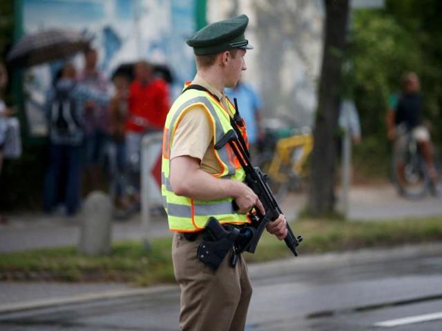 A police officer secures a road near to the scene of a shooting rampage at the Olympia shopping mall in Munich. (reuters) A police officer secures a road near to the scene of a shooting rampage at the Olympia shopping mall in Munich. (reuters)